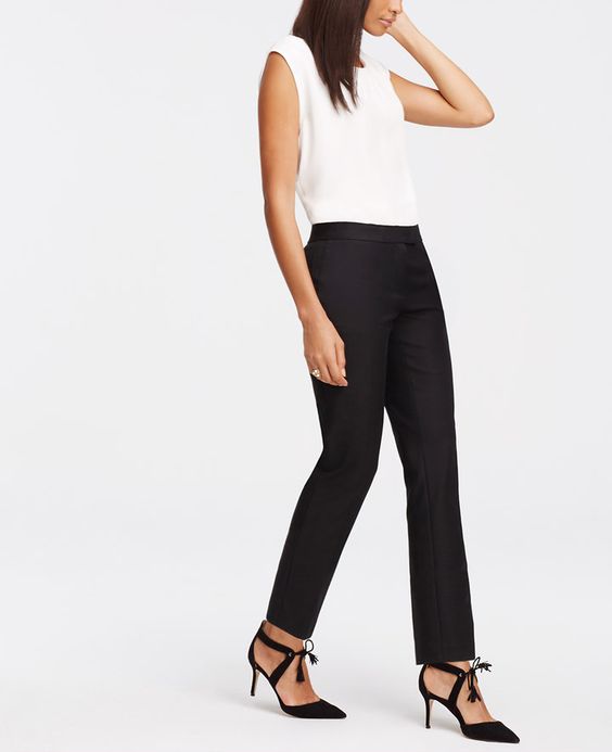 Model styled in white shirt and black pants