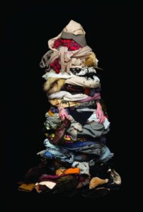 Large pile of clothes with a black background