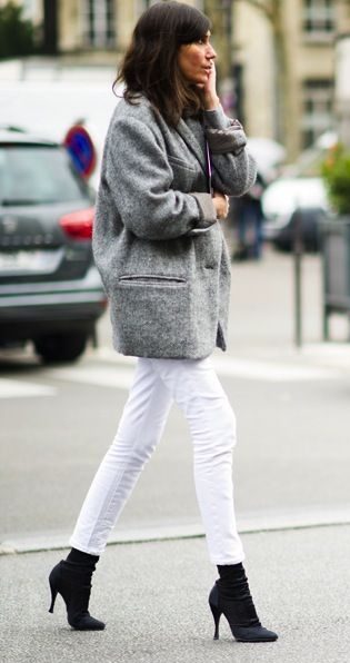 Tanned model styled in grey coat with white pants