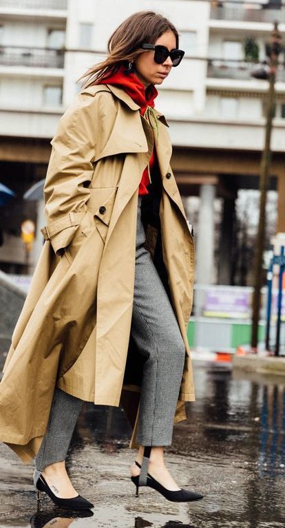 Tanned model styled in brown oversized trench coat walking