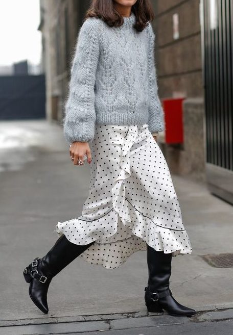 Model styled in a greyish blue sweater with a polkadot skirt