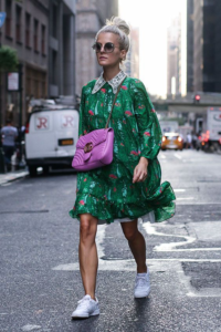 White model in green dress with white sneakers