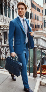 White male model styled in bright blue fitted suit