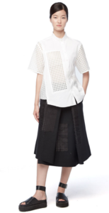 Asian woman wearing white shirt with knee-length black skirt