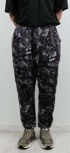 Model wearing baggy pants with a grey splatter print