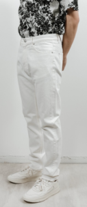 Model styled in white jeans with white shoes