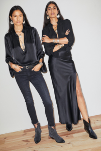 Two women fashioned in all black with their arms crossed