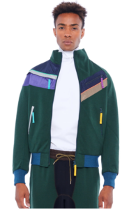 Black male model wearing 90s style green jacket with multicoloured stripes