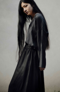 Asian model styled in grey sweater and long black skirt