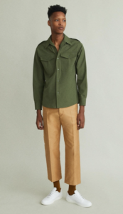 Black male model styled in a forest green dress shirt