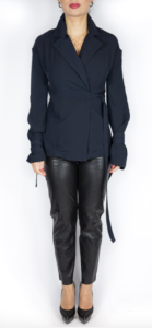 White model styled in a bluish black shirt and black leather pants