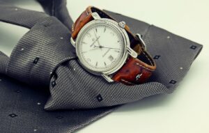 A fashionable watch on top of a grey tie