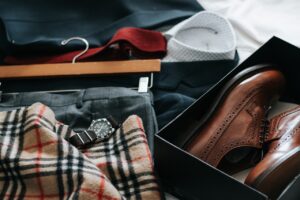 Organized pile of men's clothing and shoes